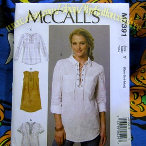 May include: A McCall's sewing pattern showing a woman in a white lace-up shirt. The pattern includes illustrations of various shirt styles, such as a long-sleeved shirt and a sleeveless tunic. The pattern is size Y (Xsm-Sml-Med).