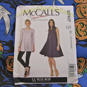 May include: A McCall's sewing pattern, M7407, featuring two dress designs. The pattern includes sizes E5 (14-16-18-20-22). The cover shows illustrations of the finished garments. The pattern is by Melissa Watson.