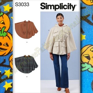 May include: Simplicity S3033 sewing pattern featuring a hooded cape with pockets and a belt. The pattern includes options for a solid brown cape, a plaid cape, and a cream-colored cape. The model is wearing the cream cape with dark blue jeans.