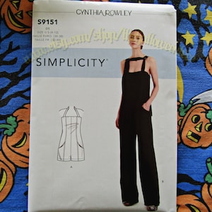 May include: A Simplicity sewing pattern envelope S9151 by Cynthia Rowley for a jumpsuit and romper. The white envelope features the text S9151, D5, SIZE U.S. (4-12), TAILLE EURO. (30-38), TAILLE FR. (32-40), and displays a black jumpsuit and a romper sketch.