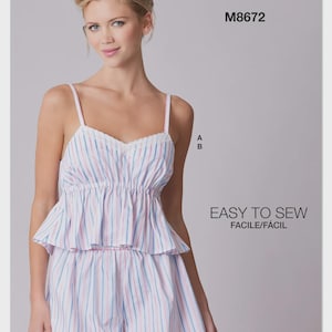 May include: McCall's M8672 sewing pattern for a two-piece pajama set featuring a camisole top with thin straps and lace trim, paired with matching shorts. The fabric has a vertical striped pattern in light blue, pink, and white colors.