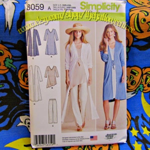 May include: Simplicity sewing pattern 8059 features designs for a long cardigan, dress, and pants. The pattern includes images of the finished garments. The package is white with text and images, and the American Sewing Guild logo.