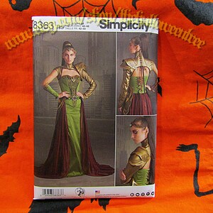 May include: Simplicity sewing pattern number 8363 for a fantasy costume with a green and burgundy dress, gold and brown armour, and a high collar. The pattern is for sizes 14-22, UK sizes 10-18, Euro sizes 40-48, and French sizes 42-50.