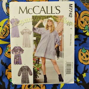 May include: A sewing pattern for a dress with a gingham pattern. The pattern is for sizes X-Small, Small, and Medium. The pattern is McCall's M7742.