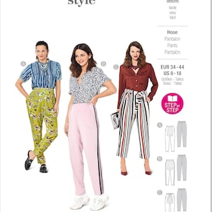 May include: A fashion magazine cover featuring three women modeling different styles of pants. The magazine cover has the text "burda style" in pink. The pants include floral print, solid pink with a side stripe, and striped pants. The size range is US 8-18.