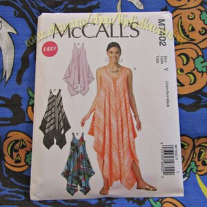 May include: McCall's sewing pattern M7402 featuring a sleeveless dress with a V-neckline. The pattern includes multiple design options, with illustrations of the finished garments in various colors and patterns. The package is labeled "EASY".