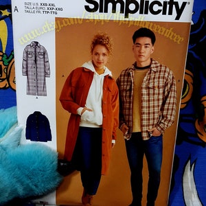 May include: Simplicity sewing pattern R11228 for a long-sleeved shirt with a plaid design. The pattern includes instructions for sizes XXS-XXL. The image shows two models wearing the shirt in different colors and styles.