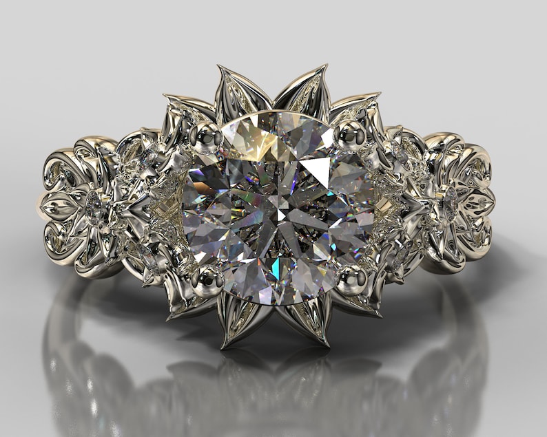 May include: A gold engagement ring with a large, round, clear diamond center stone. The ring is set with smaller diamonds on the band and features a floral design.