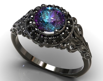 May include: A black ring with a large, round, iridescent gemstone surrounded by smaller black gemstones. The ring has a detailed, ornate design with leaf-like accents.