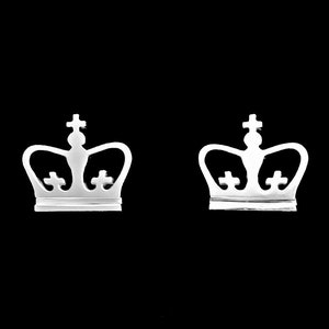 May include: A pair of silver crown-shaped earrings. The crowns have a simple design with a pointed top and three small circles on the crown.