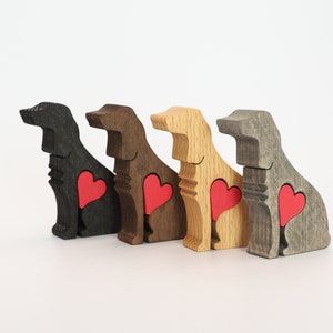 May include: Four wooden dog figurines, each painted a different color: black, brown, natural wood, and gray. Each dog has a red heart cutout on its chest.