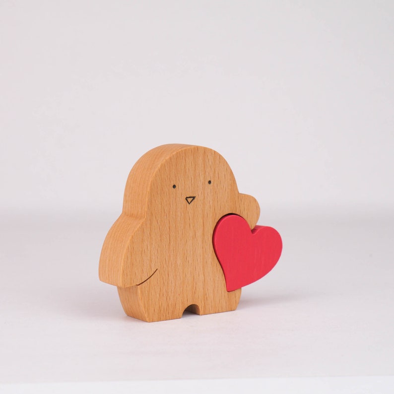 wooden penguin figurine with love heart