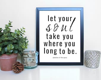 May include: Black and white framed print with the quote "let your soul take you where you long to be."  The quote is attributed to "phantom of the opera".