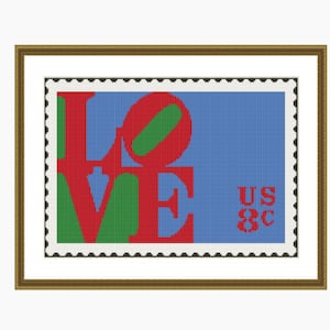 May include: A framed print of a vintage US postage stamp featuring the word "LOVE" in red, green, and blue letters. The stamp also includes the text "US 8c".