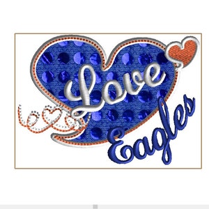 May include: Embroidered design featuring a blue heart with white text reading "Love" and the word "Eagles" in blue script. The heart has a blue polka dot pattern and a red and white border. A small heart is attached.