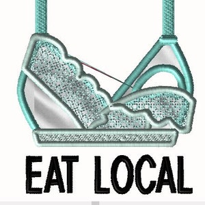 May include: A turquoise blue bra-shaped graphic with the text "EAT LOCAL" in black below it.