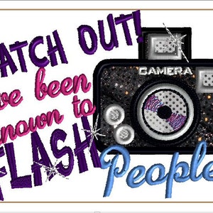 May include: Purple and pink embroidered text reads "Watch Out! I've been known to FLASH People!" with a black and silver camera graphic with a sparkly background.