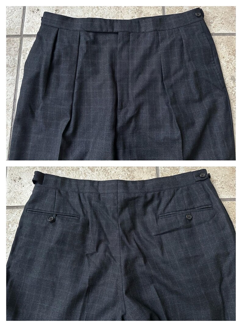 May include: A pair of dark gray plaid pants with pleats and button closures. The pants have two back pockets with buttons.