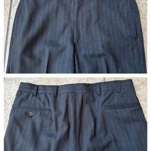 May include: A pair of dark gray pinstripe dress pants with a button on the back pocket.