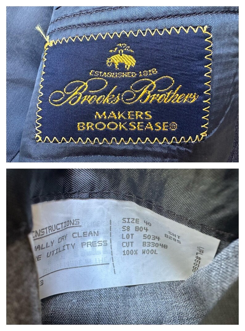May include: A navy blue suit jacket label with gold embroidery that reads "Brooks Brothers Makers Brookseaseo" and "Established 1818". A white tag attached to the jacket reads "Instructions: Dry Clean, Utility Press, Size 40, 58 804, SHT 8285, Lot 5034, Cut 833048, 100% Wool".