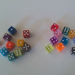 May include: A collection of colorful dice with white dots. The dice are arranged in two groups, one group of 10 and another group of 8.