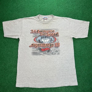 May include: Gray t-shirt with a Hot Wheels logo and the text "Life should be loud...supercharge it!"