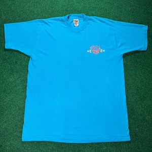 May include: A turquoise blue t-shirt with a colorful graphic that says "We  En"