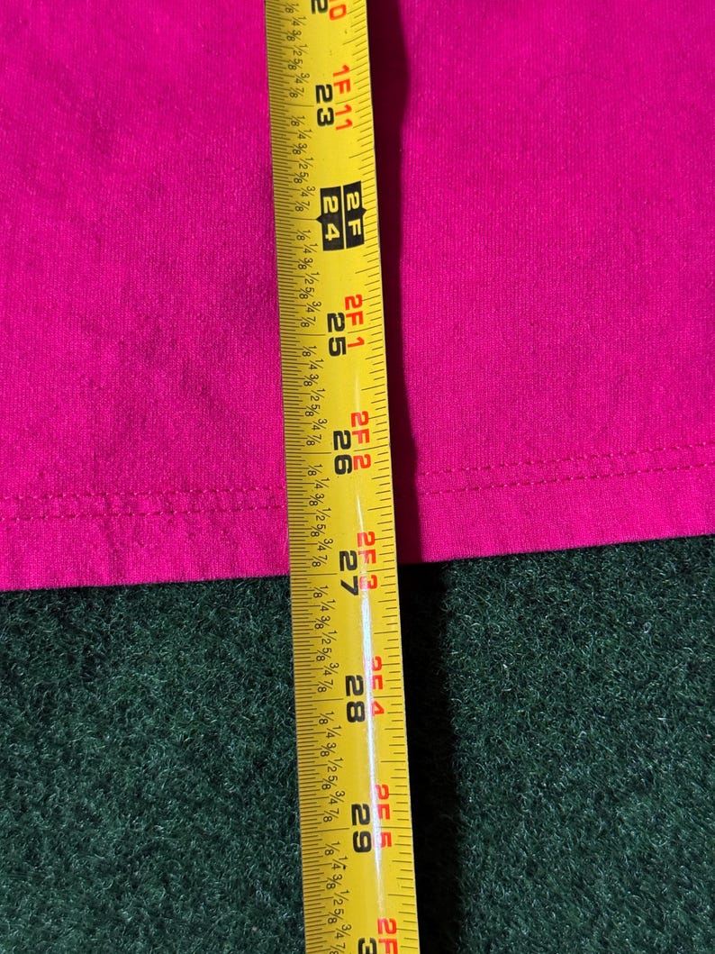 May include: A close-up of a yellow measuring tape with black markings. The tape is extended to 29 inches and shows markings for 1/8, 1/4, 1/2, and 3/4 inches.
