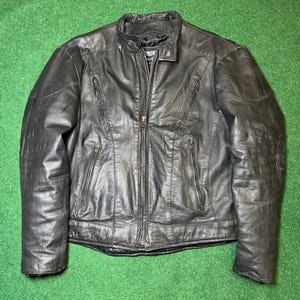 May include: Black leather motorcycle jacket with a zip fastening and multiple pockets.