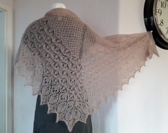 May include: A delicate, hand-knitted shawl in a light brown colour. The shawl features a lacy pattern and a scalloped edge.