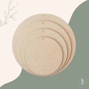 May include: A set of four circular light-colored wooden discs stacked on top of each other. Each disc is labeled with its diameter in inches, specifically 4 inches, 5 inches, 6 inches, and 7 inches, printed clearly on the surface of the wood.