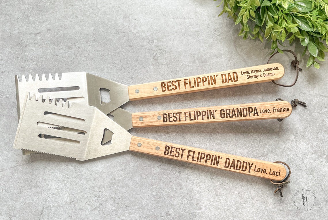Three silver spatulas with brown wood handles