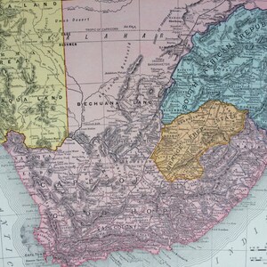 May include: A detailed vintage map of South Africa, showing geographical features and political divisions. Key areas include Cape Colony, Orange Free State, and the South African Republic. The map uses a colour scheme of yellow, pink, blue, and green.