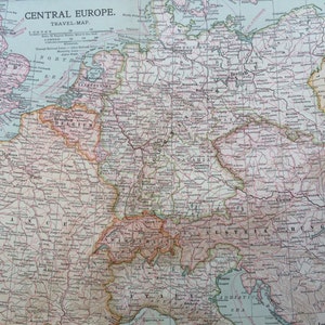 May include: A vintage map of Central Europe, featuring countries like Germany, France, and Austria. The map is detailed with city names, borders, and geographical features, printed in shades of pink, brown, and beige. The title "CENTRAL EUROPE" is at the top.