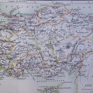 May include: Antique map of Asia Minor, featuring detailed geographical information. The map uses a vintage color palette with various place names and geographical features. The scale is indicated in Roman miles.