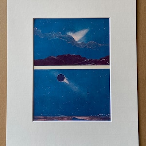May include: A framed print with two celestial landscape scenes. The top scene shows mountains under a blue sky with a bright light. The bottom scene depicts a dark planet and a comet against a starry blue backdrop. The print is mounted in a white mount.