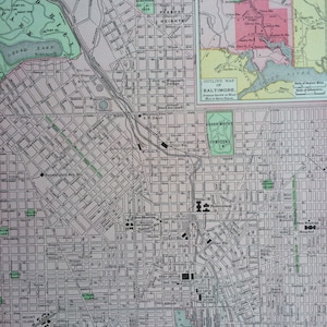May include: A vintage map of Baltimore, Maryland, showing detailed street layouts, railways, and tram lines. The map includes an outline map and an explanation section. The map is printed in shades of grey, green, pink, and yellow.