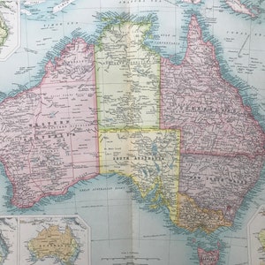 May include: A vintage map of Australia showing the states of Western Australia, Northern Territory, South Australia, Queensland, New South Wales, and Tasmania. The map is printed on a light blue background with brown lines and text.