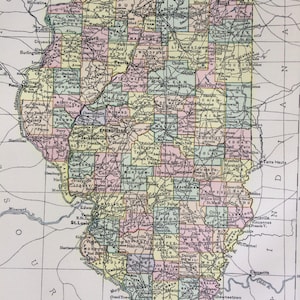 May include: A vintage map of Illinois, displaying county borders in different colours. The map includes cities, towns, railways, and canals, with a scale of miles at the bottom. The map is a detailed representation of the state's geography.