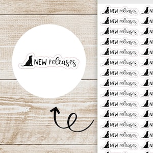 May include: A sheet of clear stickers with black dog illustrations and the text "NEW releases". The stickers are arranged in rows and columns on a wooden background. The sheet is labeled "Black Dog Sticker Co." and "MX-081".