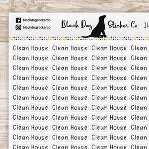 May include: A sheet of white stickers with the text "Clean House" repeated multiple times. The stickers are on a wooden background.