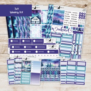 May include: A 7x9 weekly planner kit with a purple and teal color scheme. The kit includes various stickers and labels with images of a house, trees, and a night sky. Text includes "Weekly Kit", "Weekend", and days of the week.