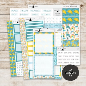 May include: A collection of planner stickers with a weather theme. The stickers feature umbrellas, rainbows, and rain boots in yellow, blue, and teal. Includes date covers, daily scripts, and boxes for notes. The text "A5 Daily Duo Kit" is visible.