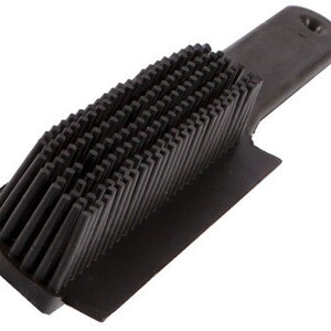 The Rubber Splines of a Berkeley Dog Hair Remover Brush quickly brush away pet hair.