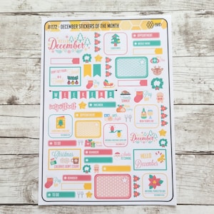 May include: A sheet of colorful December themed stickers with various designs including a Christmas tree, a Santa Claus, a gingerbread man, a reindeer, and a snowman. The stickers are perfect for planners, journals, and other creative projects.