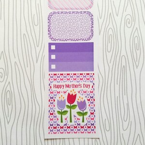 May include: A sheet of decorative stickers with a Mother's Day theme. The stickers feature floral and butterfly patterns in shades of pink, purple, and red. The text "Happy Mother's Day" is displayed on one of the stickers.
