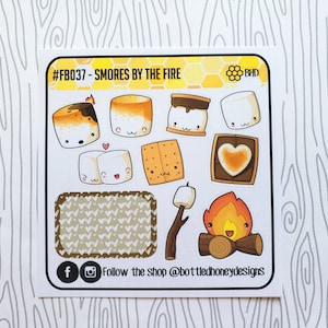 May include: A sheet of stickers featuring a campfire and various s'mores. The stickers are illustrated in a cartoon style with cute faces. The text on the sheet reads "#FB037 - SMORES BY THE FIRE" and "Follow the shop @bottledhoneydesigns".