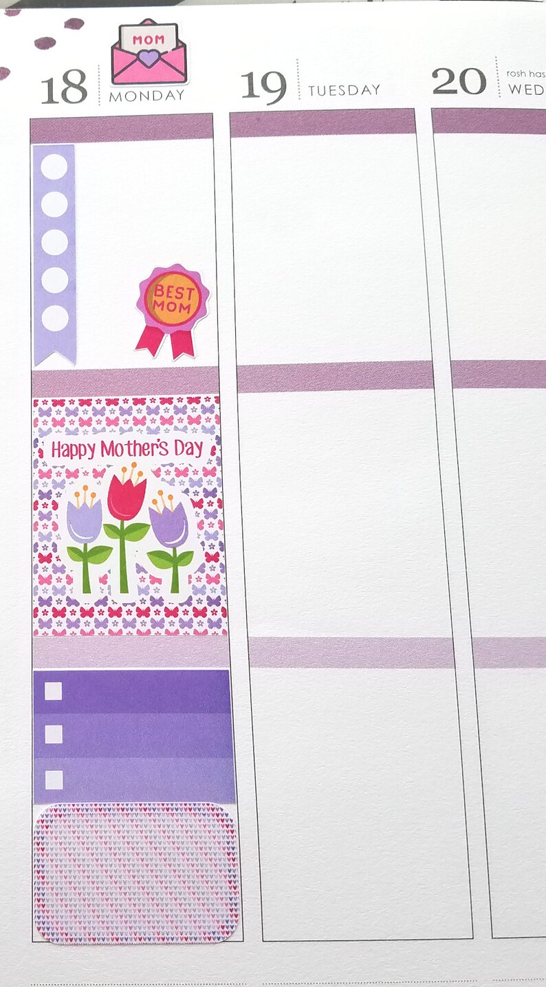 May include: A planner page with decorative stickers for Mother's Day. The stickers include a pink envelope with "MOM" text, a "BEST MOM" ribbon, and a floral design with the text "Happy Mother's Day".