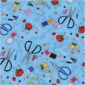 May include: A blue fabric with a repeating pattern of sewing supplies. The pattern includes scissors, spools of thread, buttons, needles, and pincushions. The fabric is perfect for quilting, crafts, and home decor.