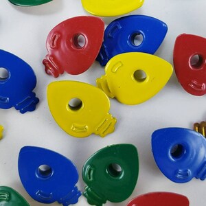 May include: Assortment of colorful light bulb shaped ornaments in red, yellow, blue, and green.